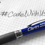 photo of handwritten #codewithus on graph paper with a blue Clarity pen