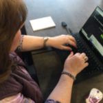 photo of a woman working on a laptop at a desk
